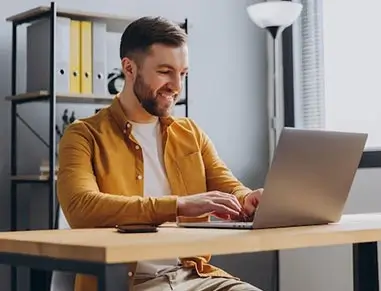 Guy On Computer Looking At Quote Rocket